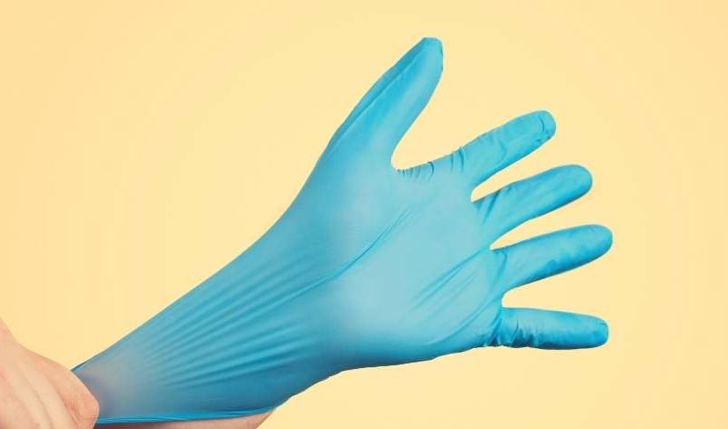 putting on a medical glove