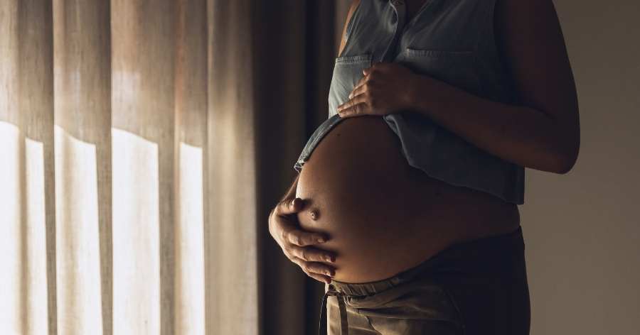 pregnant woman in darkened room