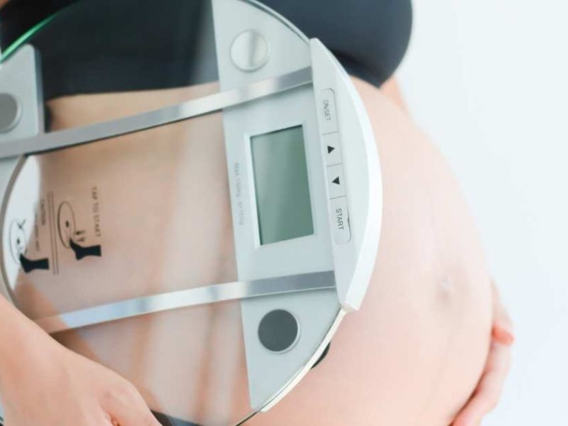 pregnant woman with a scale