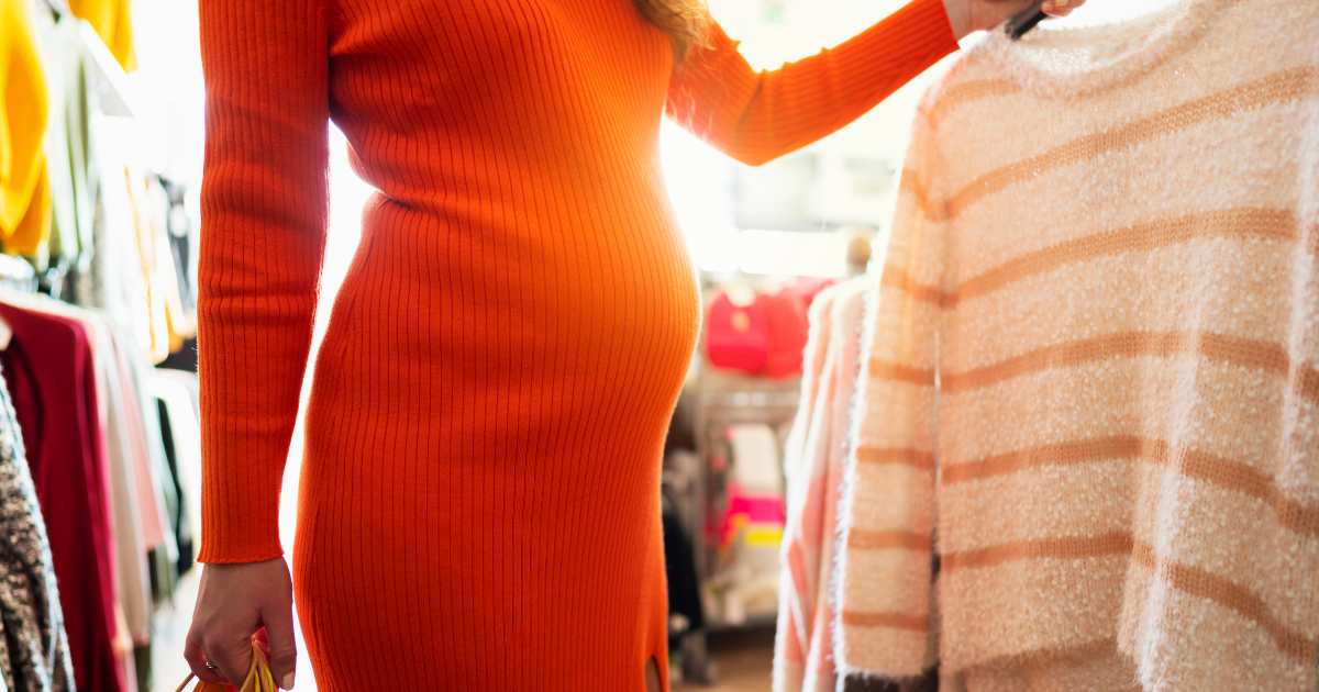 pregnant woman shopping for clothes