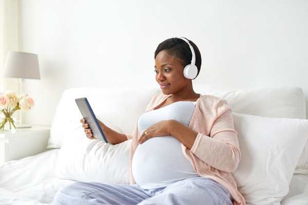 pregnant woman listening to a podcast