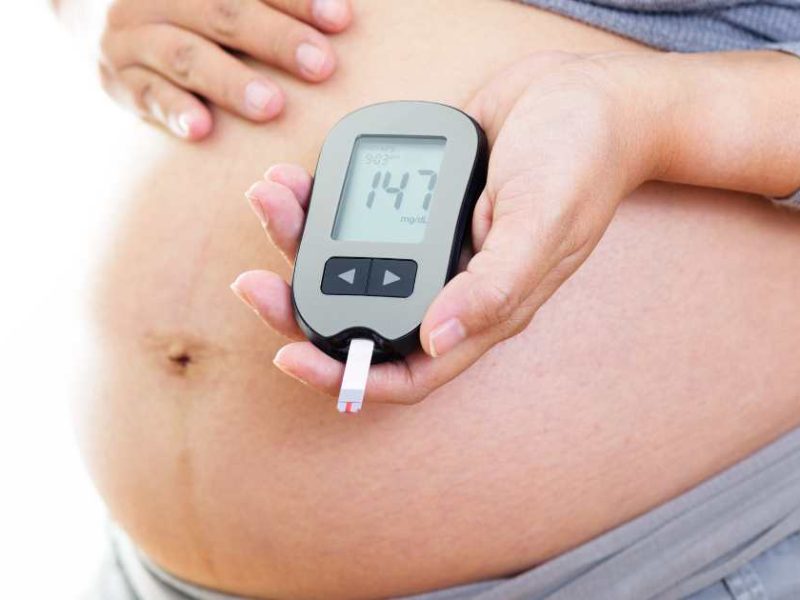 pregnant woman with glucose monitor