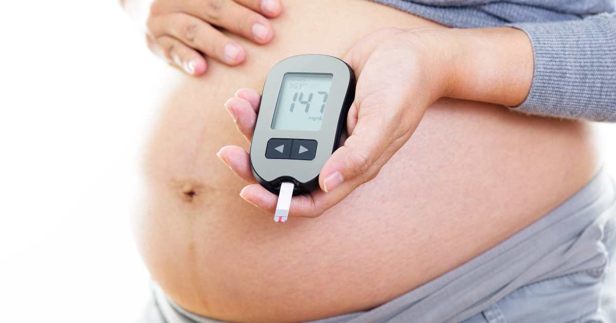 pregnant woman with glucose monitor
