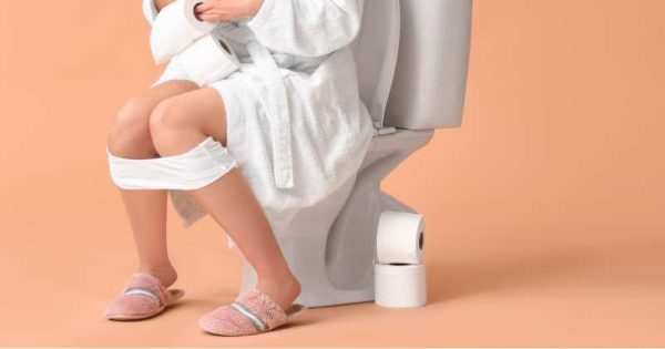pregnant woman having diarrhea on the toilet