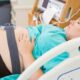 pregnant woman, wiht fetal monitors on in bed.