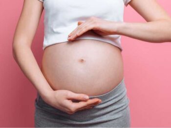 pregnant woman with hands framing belly