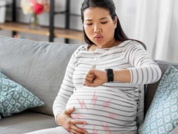 pregnant woman contracting looking at her watch
