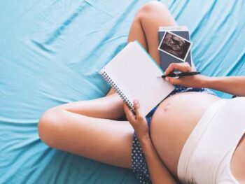 pregnant woman holding a notebook