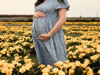 pregnant woman in a field of primrose