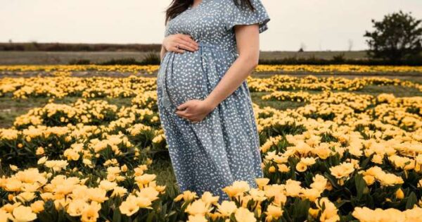 pregnant woman in a field of primrose