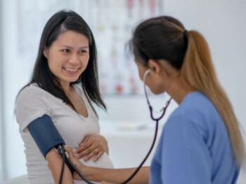 pregnant woman getting her blood pressure checked