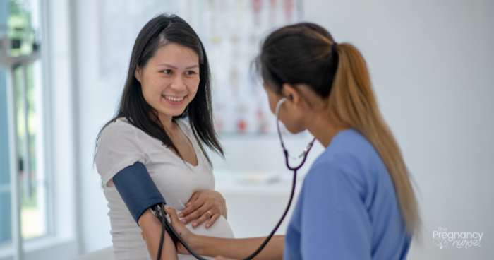 pregnant woman getting her blood pressure checked