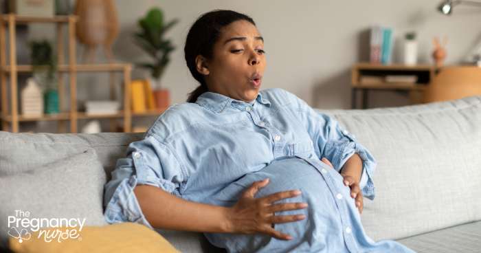 pregnant woman breathing through a contraction at home