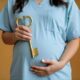 pregnant woman holding a golden key