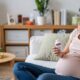 pregnant woman holding a bottle of tylenol