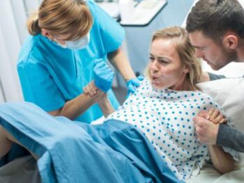 pregnant woman pushing out a baby