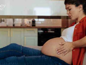 pregnant woman in pain on the couch
