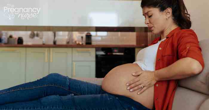 pregnant woman in pain on the couch